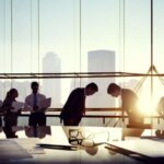 Business professionals exchanging bows during a formal meeting in Japan